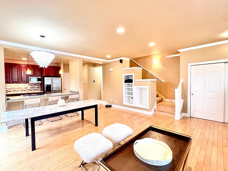 Living room and stairs to second floor. All furniture displayed is included.
