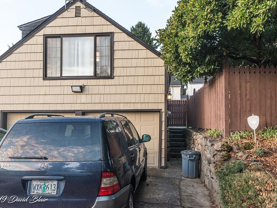 Street view, studio apartment above garage. Entry stairway on right.