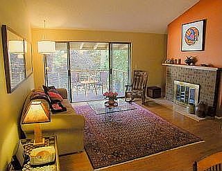 Living room, fireplace, and front deck