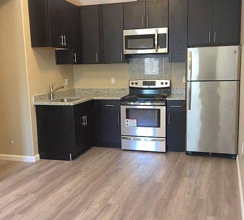 Kitchen with free standing range, microwave and refrigerator