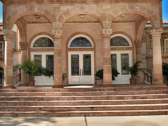 Magnificent entrance crafted by stone masons with impressive front doors.
