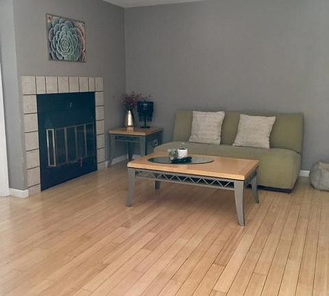 Living room with wood-burning fireplace.