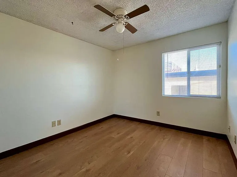 East Smaller bedroom, newly-installed wood laminate flooring and new mini-blinds