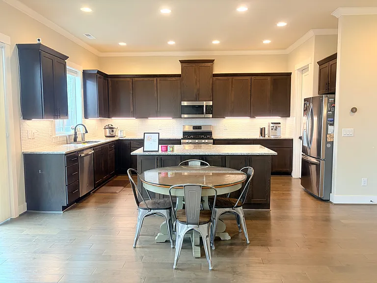 Bright kitchen with granite island and breakfast nook.