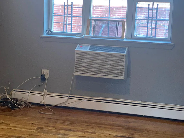 living room with hardwood floors and AC unit