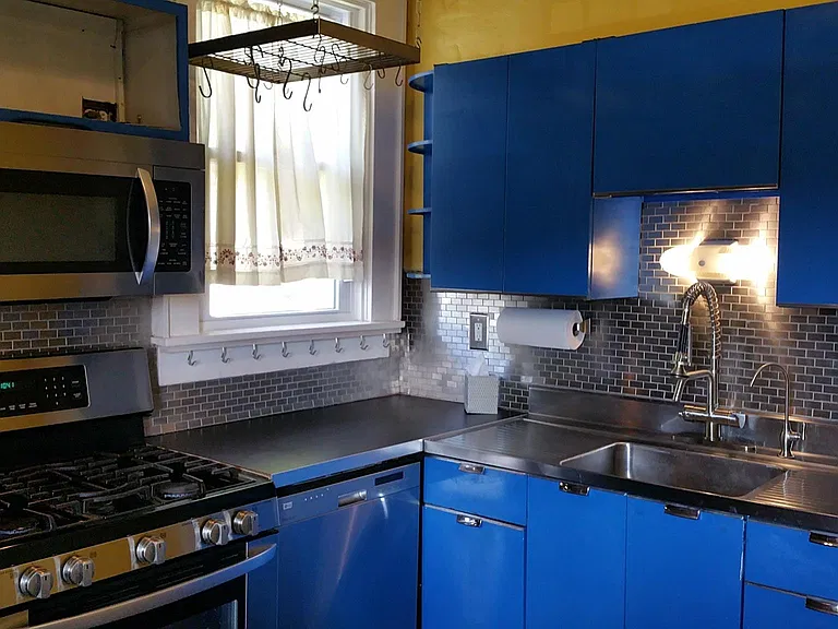 Renovated kitcehn with fullsize energy efficent dishwasher, garbage disposal in sink, LG range, LG Micro-hood that vents to the outside! Restored vintage cabinets, and pot rack allow for more storage.
