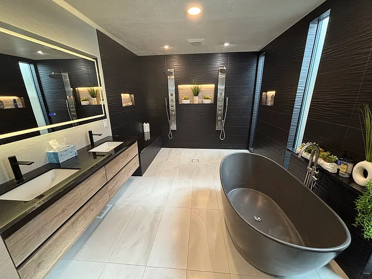 Primary bathroom with dual showers, double sink and soaking tub.