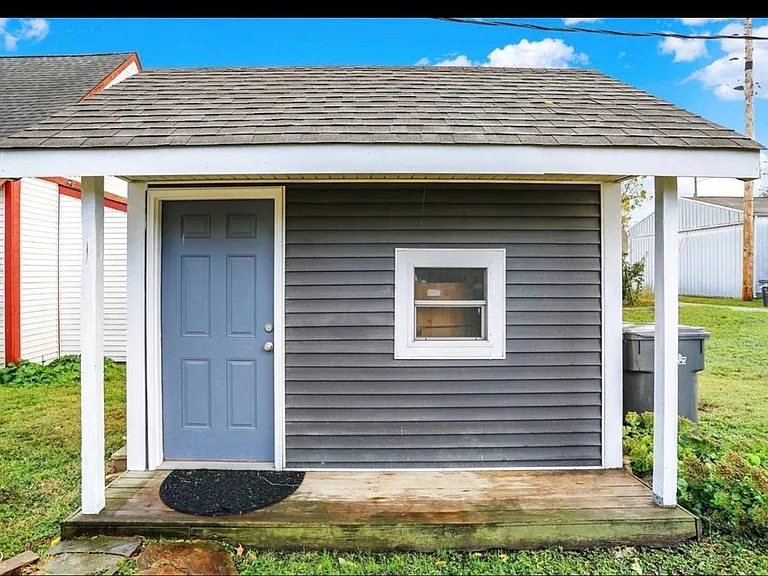 Outdoor shed area offers additional space for storage or flex use
