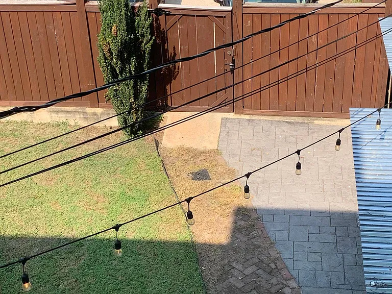 View of the backyard and two dedicated, off-street parking spaces