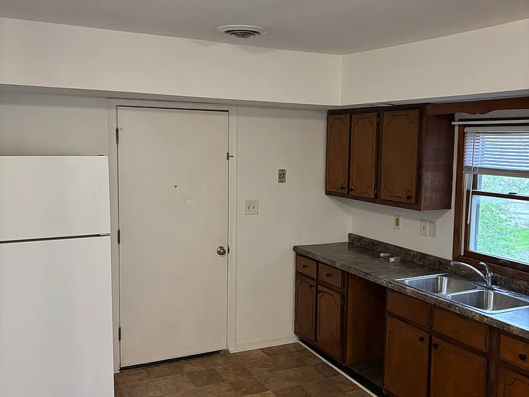 Kitchen and dining room space: refrigirator, gas range and oven, and microwave