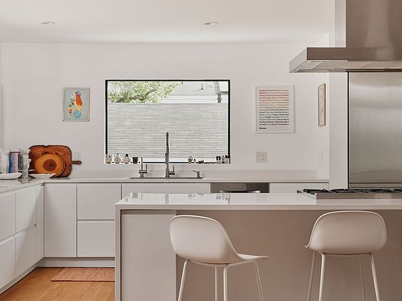 Open kitchen concept with high end appliances including BlueStar range and Liebherr refrigerator.