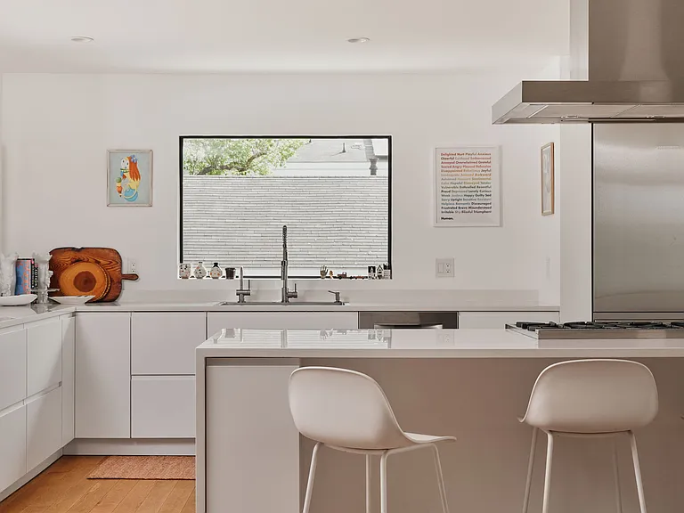 Open kitchen concept with high end appliances including BlueStar range and Liebherr refrigerator.