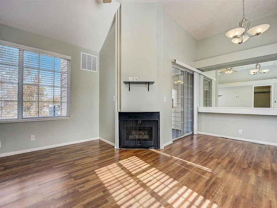 Living room, fireplace, patio door, dining area.