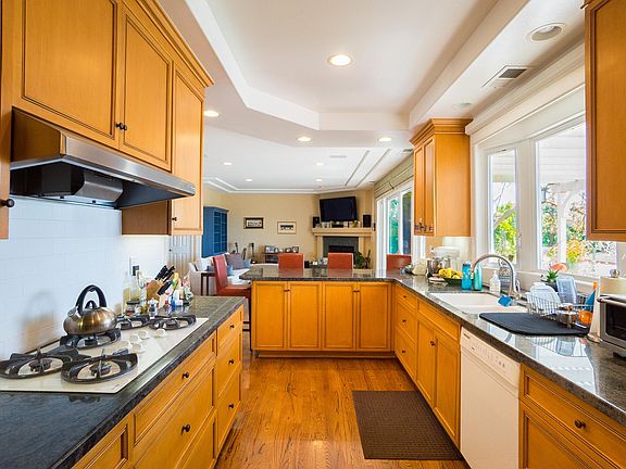 Kitchen opens to great room with views of the kids playing in the yard