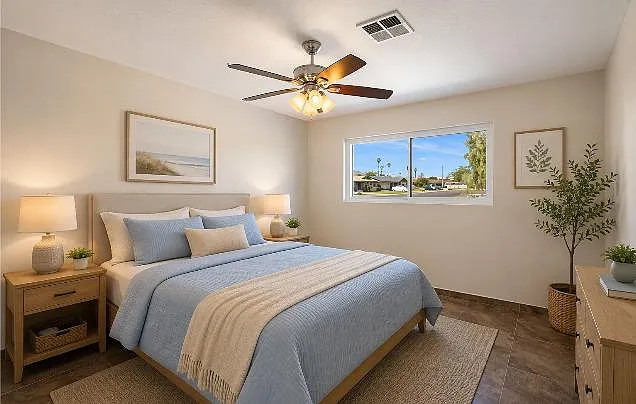 Well-sized bedroom with a ceiling fan, large window, and space for a full bed plus nightstands and dresser.