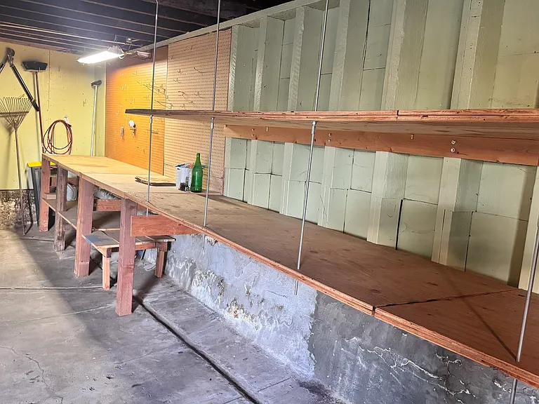 Plenty of biult-in shelving and workshop bench