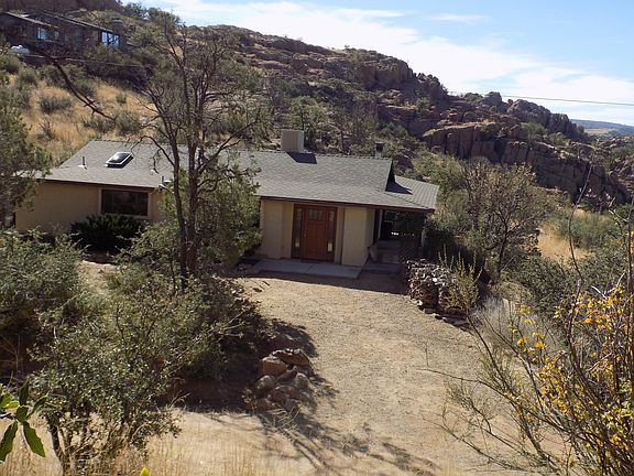 House nestled in the rocks. Parking out front.
