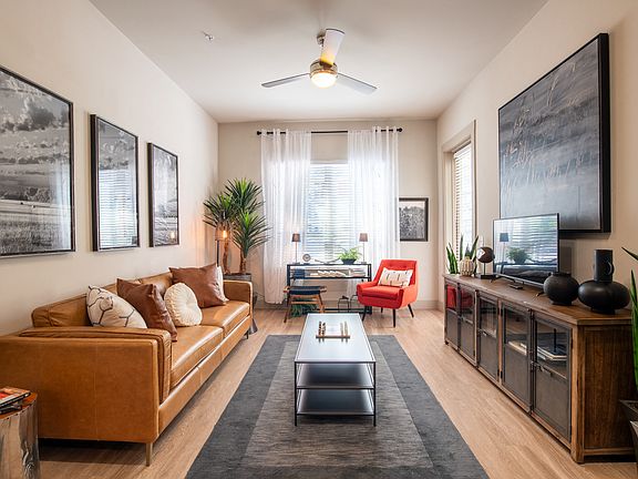 Contemporary Living Room with Wall Art, Ceiling Fan, and Desk Space