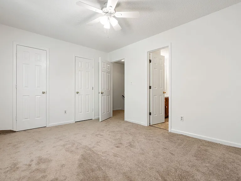 Bedroom highlighting double closets and direct bathroom access