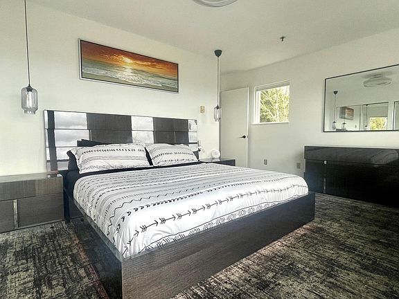 Master Bedroom with a large window to view the sunrise and a picture perfect view of the city. The bedroom has blackout shades that rise and drop with a push of a button.