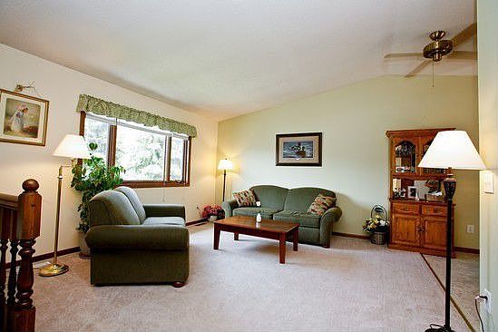 Living room has a vaulted ceiling and plenty of natural light.