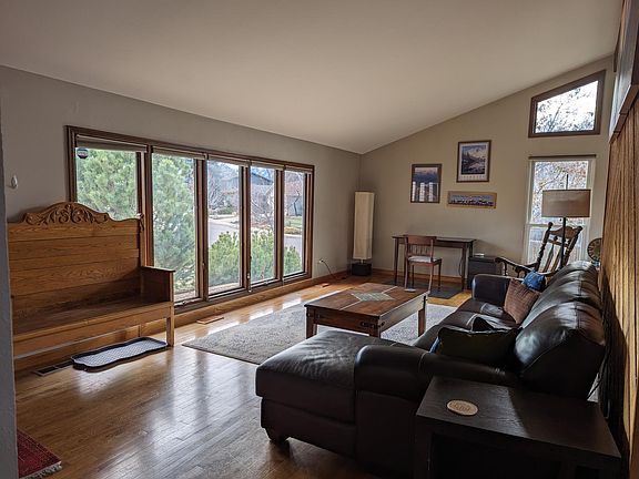 Living Room with great light and work area with view of the Flatirons.