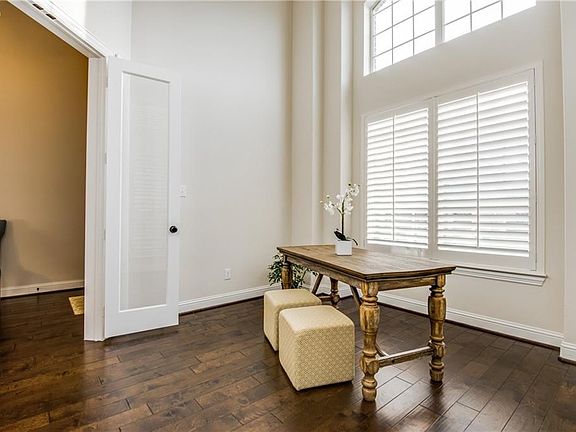 Study at front of the home features French doors and large beautiful windows with plantation shutters.