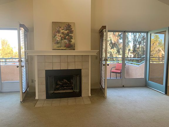 Vaulted ceiling living room with gas log fireplace.