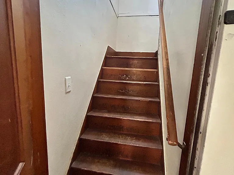 Stairs that lead to bonus space in attic.