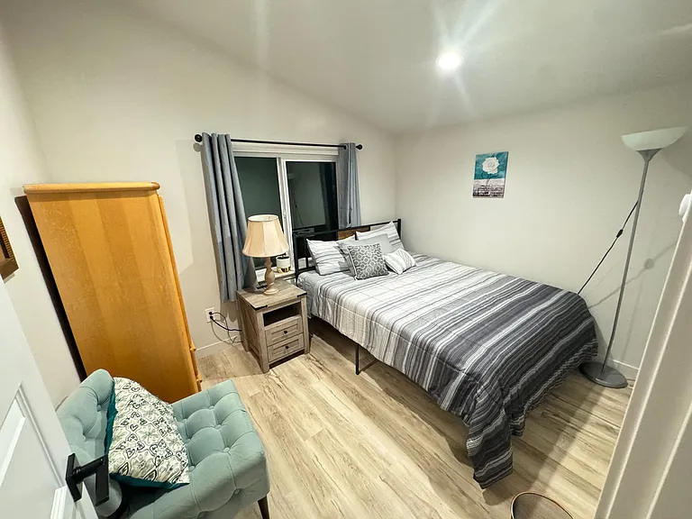 Bedroom #2 with armoire and city view