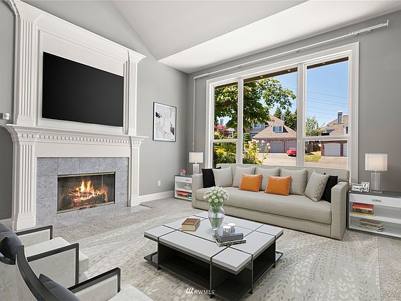 Large windows invite natural light into every room! Living room with gas F/P and formal dining. *virtually staged*>