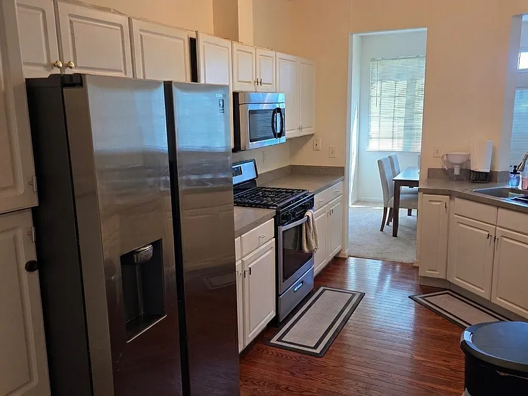 Kitchen featuring stainless steel appliances and beautiful mahogany hardwood floors