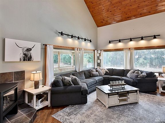 Inviting living room with vaulted ceiling and cozy propane fireplace.