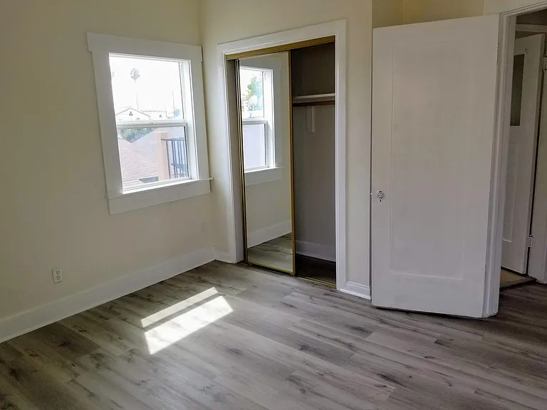 Bedroom with new floors, new window, new closet and paint