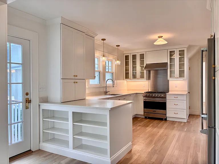 Kitchen featuring Viking 5 burner dual fuel range, Bosch dishwasher and Viking Refrigerator. Upper glass-front cabinets.
