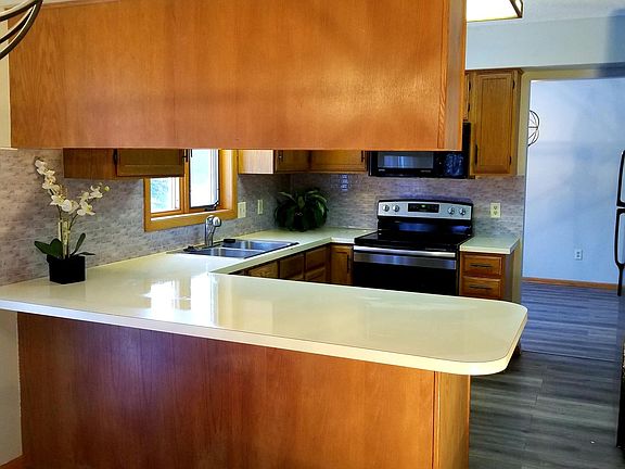 View of the eat in kitchen. The home also boasts a formal dining area an additional dine-in area that gives great views of the spacious backyard.