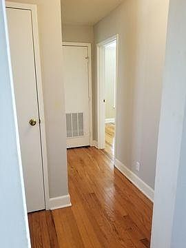 Hall to bathroom, laundry hook up, and bedrooms