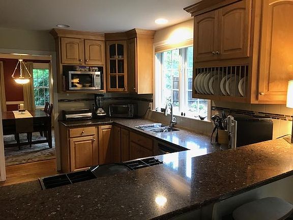 Open concept kitchen with full view of family room, deck and