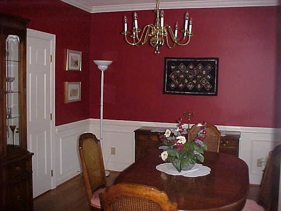 Formal dining room with wainscoting and crown molding