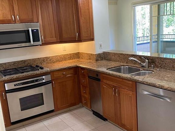 Spacious Kitchen overlooking the living room and dining room and to the extended view out beyond.