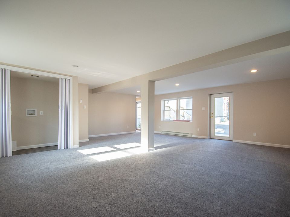 Ground level, open concept living/office/recreation room with laundry closet.