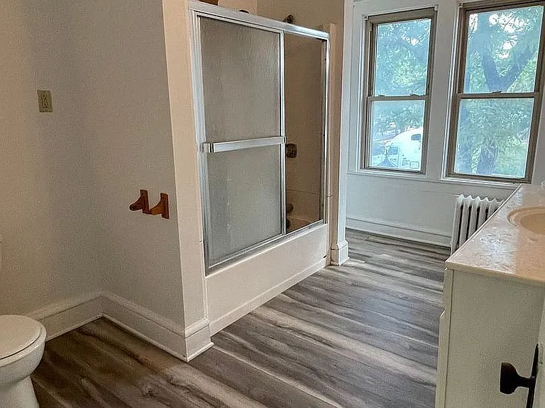 Elevate your living experience at LS Capital Group with this spacious bathroom featuring modern finishes and ample natural light. Enjoy a serene retreat that balances comfort and style. Explore your new home today!