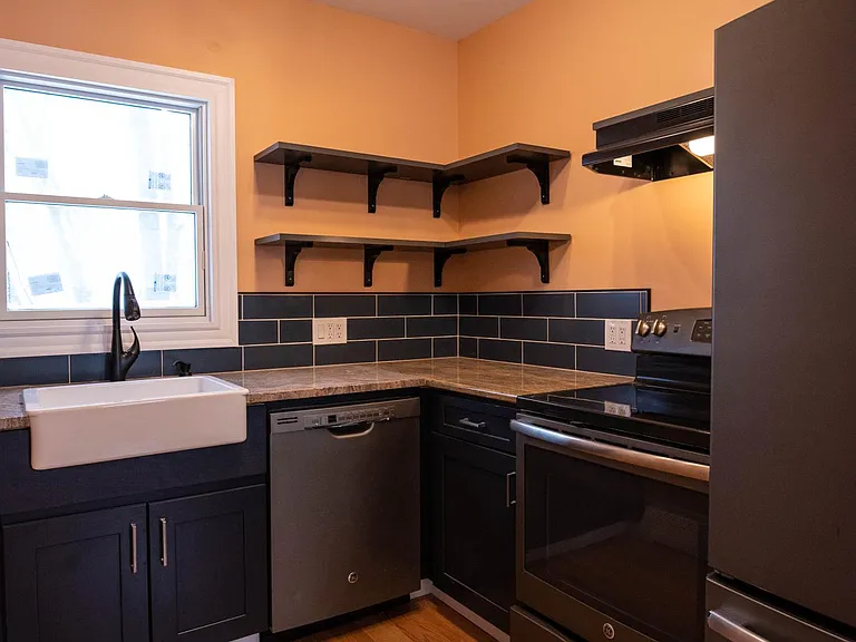 kitchen view featuring open shelving and appliances including extra large refridgerator