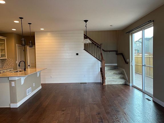 Main Floor: Open concept kitchen and dining room with ship lap access wall