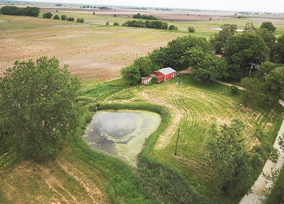 Pole building, pond, and hay field.