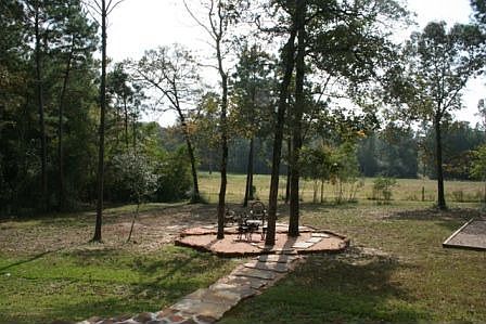 Steps to firepit area and a view of the open field.