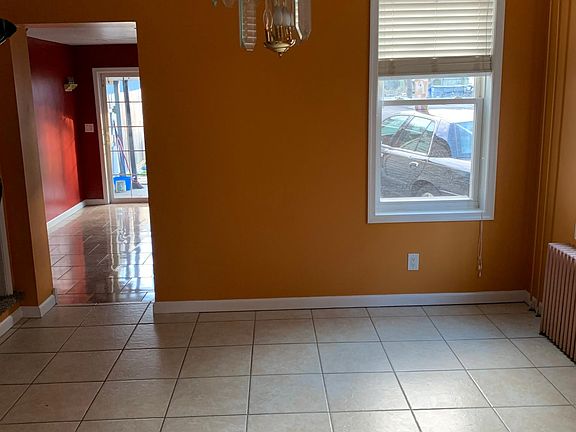 The newly painted living room with new tile floor and windows