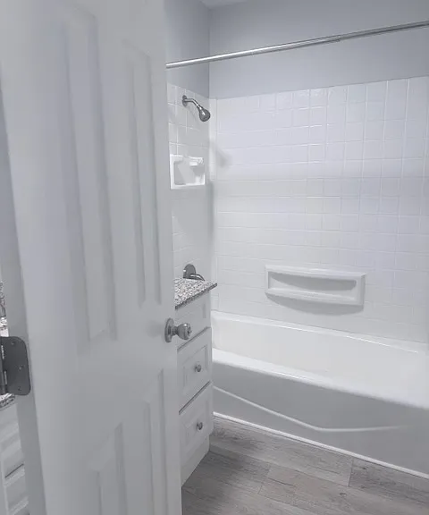 bath with sink and tub shower combo