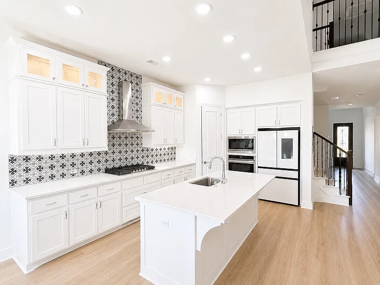 Kitchen with Quartz counter top and refrigerator