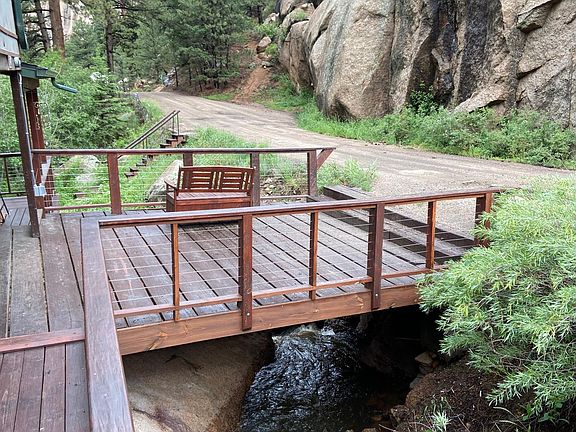 Two bridges, one a parking bridge, rise up above the water of South Elk Creek year-round. A waterfall roars below the walking bridge.